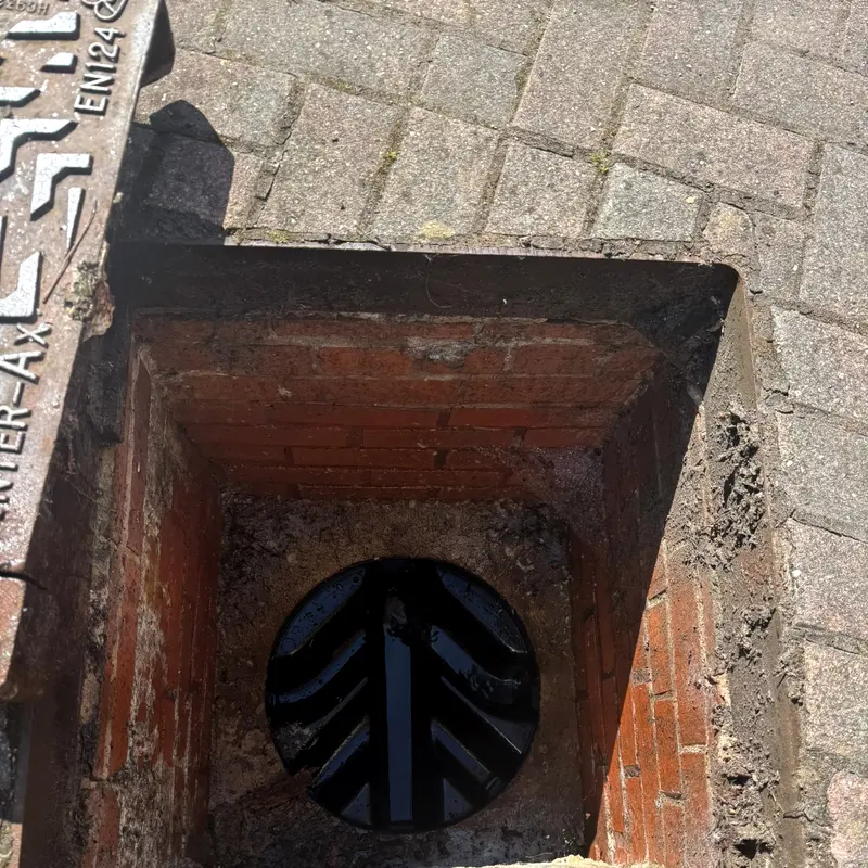 The channel of a brick manhole running clear before the dye is introduced